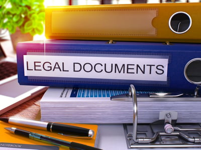 Blue Office Folder with Inscription Legal Documents on Office Desktop with Office Supplies and Modern Laptop. Legal Documents Business Concept on Blurred Background. Legal Documents - Toned Image. 3D.