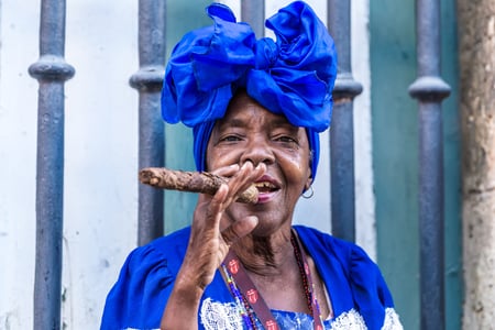 Portrait of african cuban woman smoking cigar in Havana, Cuba