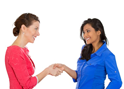 Two happy business women shaking hands, after conflict resolution, finding solution to problem, isolated white background. Positive human emotions, facial expressions, attitude